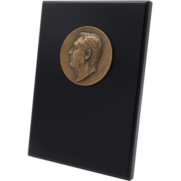 Custom bronze metope with a faceRef. code: PL0446Face in bronze on a solid wood metope lacquered in black. The face is completely personalized and is carved from a photograph achieving a surprising and faithful result.